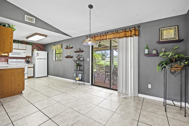 1882 SW Agnes St, Port Saint Lucie, FL 34953 - dining space featuring lofted ceiling, light tile patterned floors, and a textured ceiling