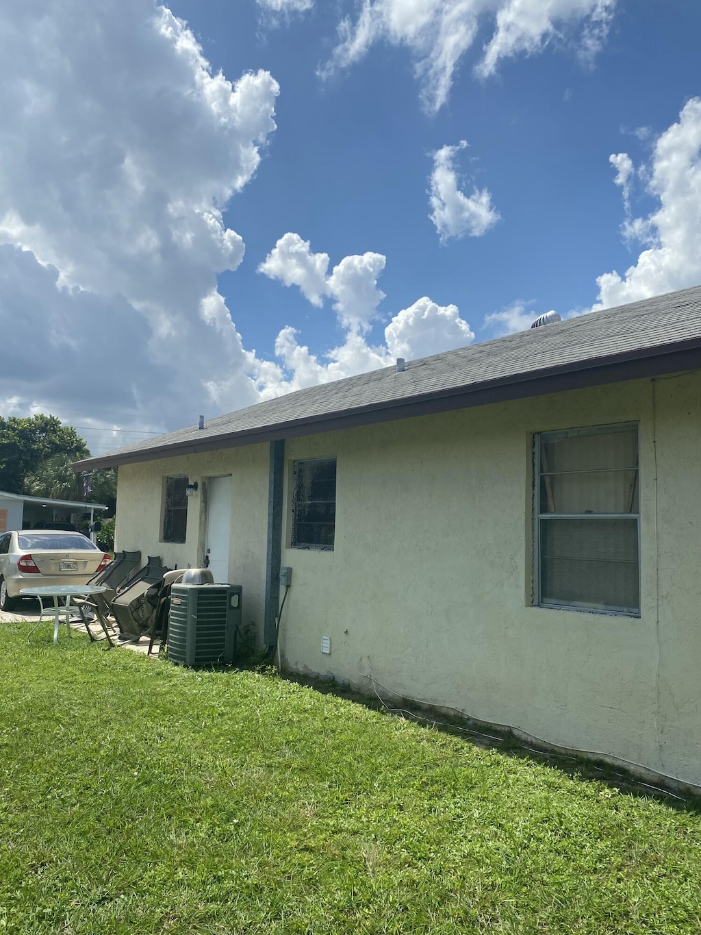 1310 W 24th St, Riviera Beach, FL 33404 - back of house featuring a yard and stucco siding