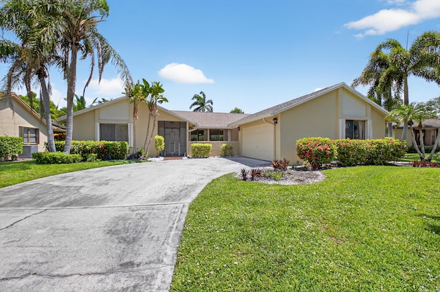 2915 NW 14th St, Delray Beach, FL 33445 - view of front of house with stucco siding, concrete driveway, an attached garage, and a front yard