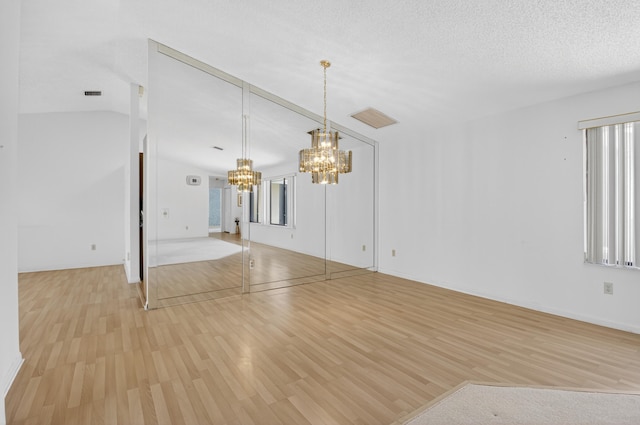 2915 NW 14th St, Delray Beach, FL 33445 - unfurnished living room featuring a chandelier and light wood-type flooring