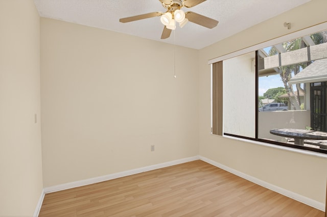 2915 NW 14th St, Delray Beach, FL 33445 - spare room with wood finished floors, ceiling fan, and a textured ceiling