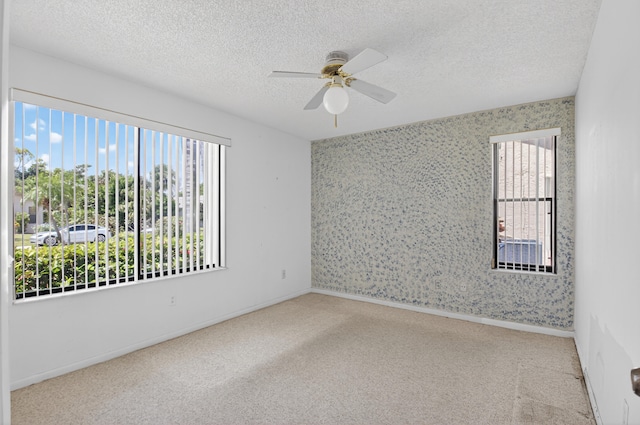 2915 NW 14th St, Delray Beach, FL 33445 - carpeted empty room featuring healthy amount of natural light, ceiling fan, and a textured ceiling