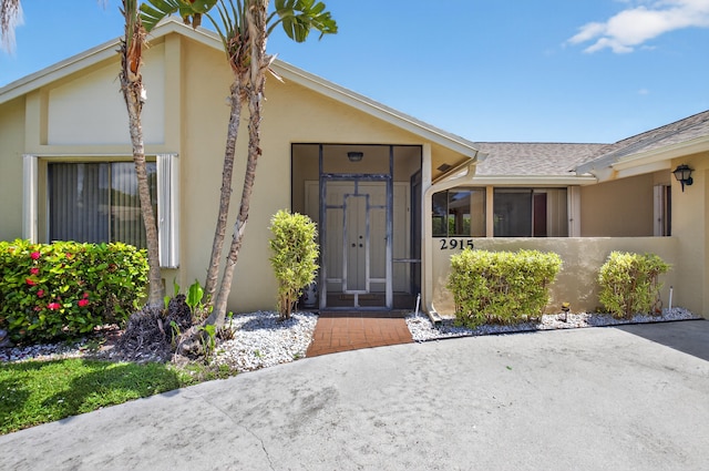 2915 NW 14th St, Delray Beach, FL 33445 - entrance to property featuring stucco siding and a shingled roof