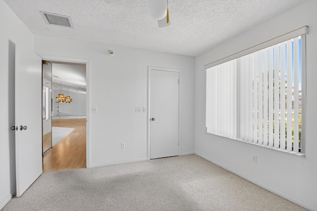 2915 NW 14th St, Delray Beach, FL 33445 - unfurnished bedroom featuring multiple windows, carpet flooring, a ceiling fan, and a textured ceiling