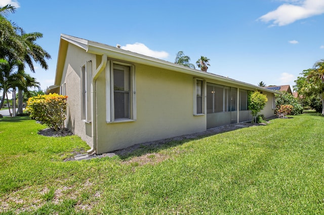 2915 NW 14th St, Delray Beach, FL 33445 - view of property exterior with stucco siding and a yard