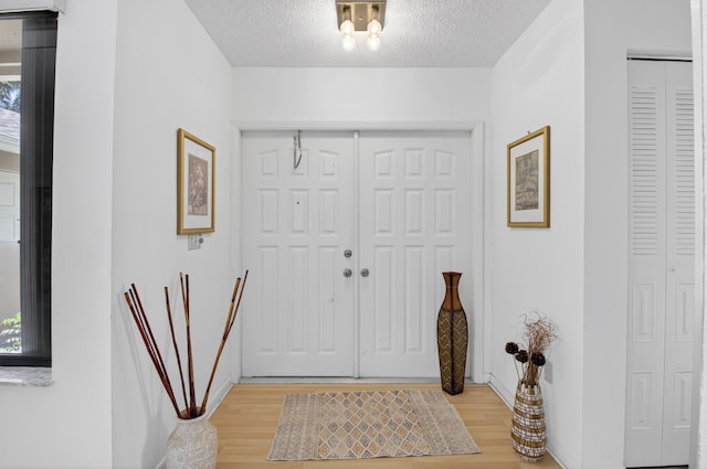 2915 NW 14th St, Delray Beach, FL 33445 - foyer with light wood-type flooring, healthy amount of natural light, and a textured ceiling