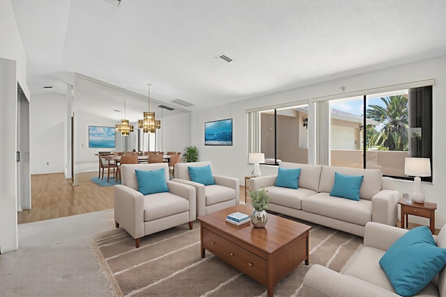 2915 NW 14th St, Delray Beach, FL 33445 - living room with a chandelier, lofted ceiling, and light wood-style flooring