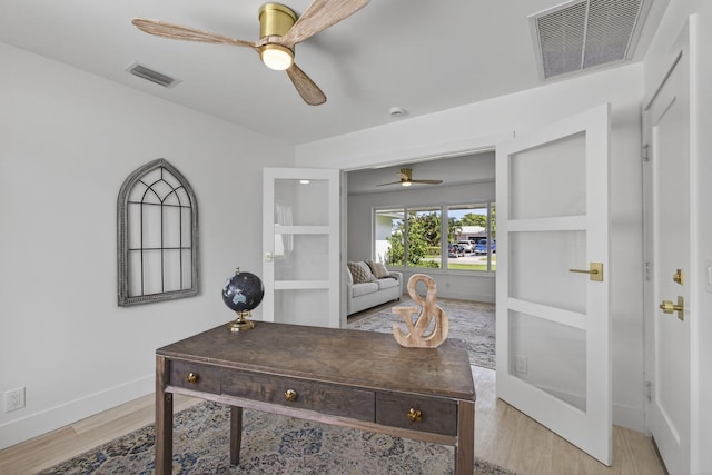 131 Cruiser Rd S, North Palm Beach, FL 33408 - home office featuring a ceiling fan, light wood-style floors, and french doors