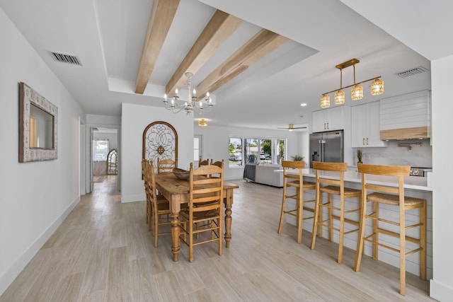 131 Cruiser Rd S, North Palm Beach, FL 33408 - dining room with light wood finished floors and a chandelier