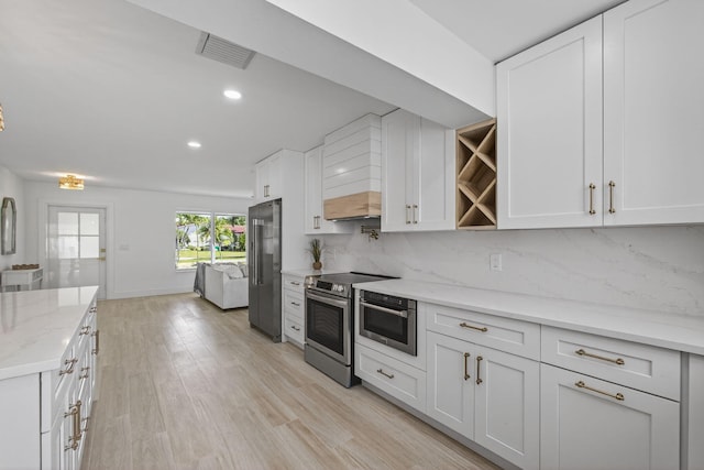131 Cruiser Rd S, North Palm Beach, FL 33408 - kitchen featuring appliances with stainless steel finishes, decorative backsplash, white cabinetry, open shelves, and recessed lighting