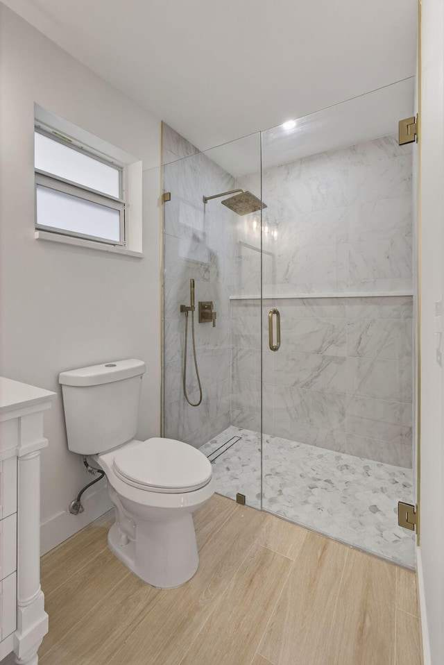 131 Cruiser Rd S, North Palm Beach, FL 33408 - bathroom with a marble finish shower, wood finished floors, and vanity