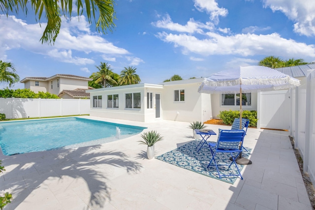 131 Cruiser Rd S, North Palm Beach, FL 33408 - view of swimming pool featuring a patio, a fenced backyard, and a gate