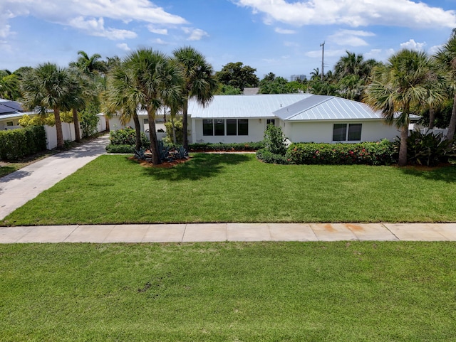 131 Cruiser Rd S, North Palm Beach, FL 33408 - view of front of property featuring a front yard, stucco siding, and concrete driveway