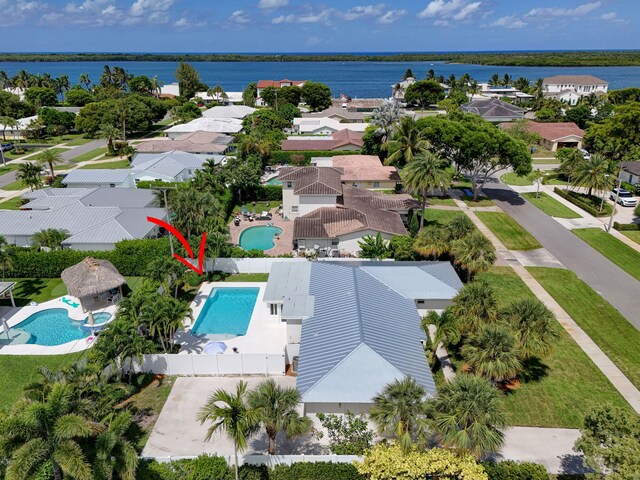 131 Cruiser Rd S, North Palm Beach, FL 33408 - aerial perspective of suburban area with a pool and a large body of water