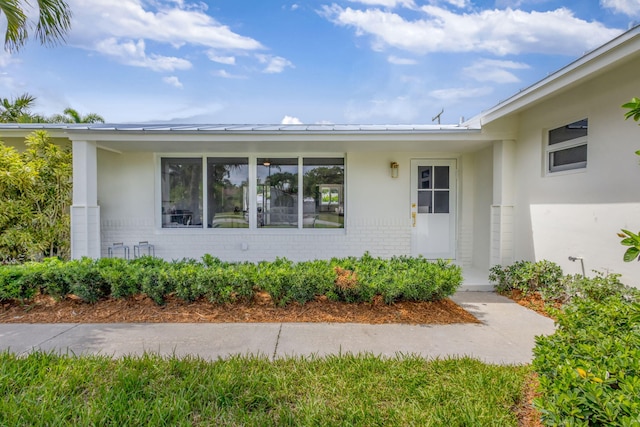 131 Cruiser Rd S, North Palm Beach, FL 33408 - property entrance with brick siding and stucco siding