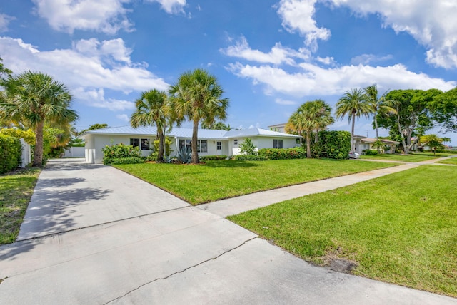 131 Cruiser Rd S, North Palm Beach, FL 33408 - ranch-style home featuring driveway, a front lawn, and stucco siding