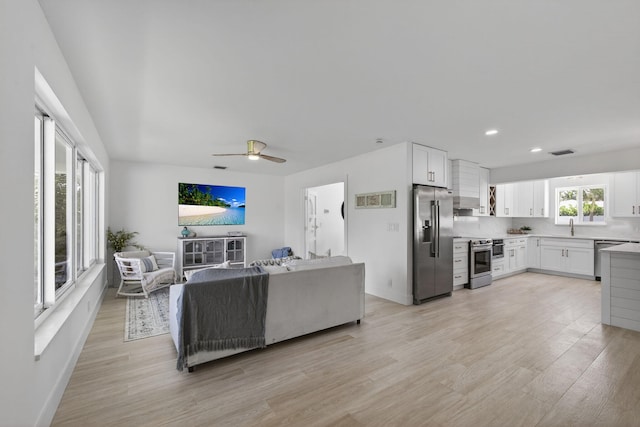 131 Cruiser Rd S, North Palm Beach, FL 33408 - living room with light wood-type flooring, a ceiling fan, and recessed lighting