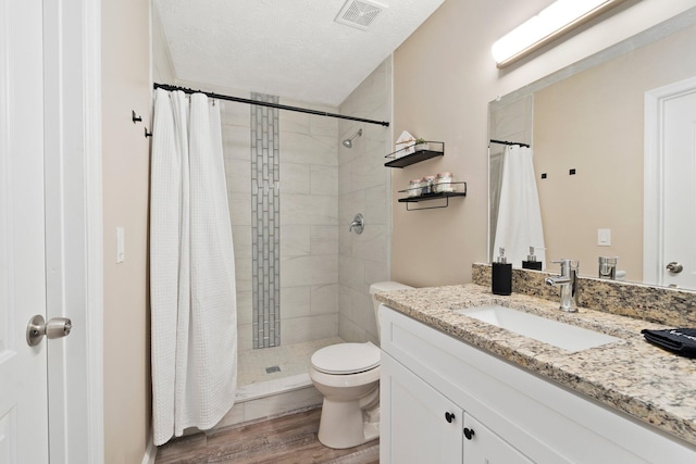 1251 SW Sudder Ave, Port Saint Lucie, FL 34953 - full bathroom with vanity, a stall shower, wood finished floors, and a textured ceiling