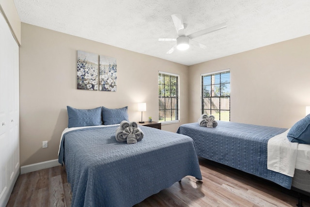 1251 SW Sudder Ave, Port Saint Lucie, FL 34953 - bedroom with wood finished floors, a textured ceiling, a ceiling fan, and a closet