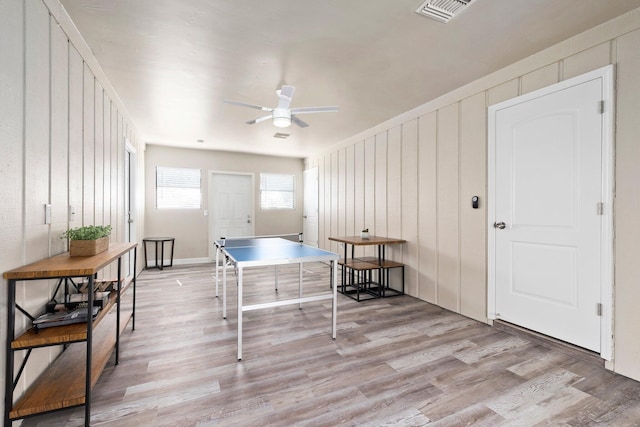 1251 SW Sudder Ave, Port Saint Lucie, FL 34953 - playroom featuring light wood-style flooring, a ceiling fan, and a decorative wall