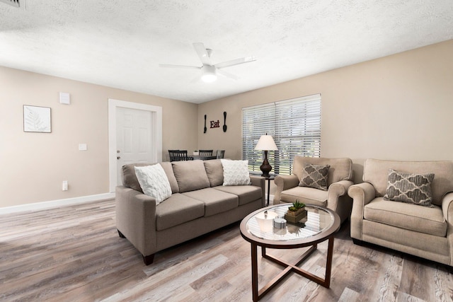 1251 SW Sudder Ave, Port Saint Lucie, FL 34953 - living room with light wood-type flooring, ceiling fan, and a textured ceiling