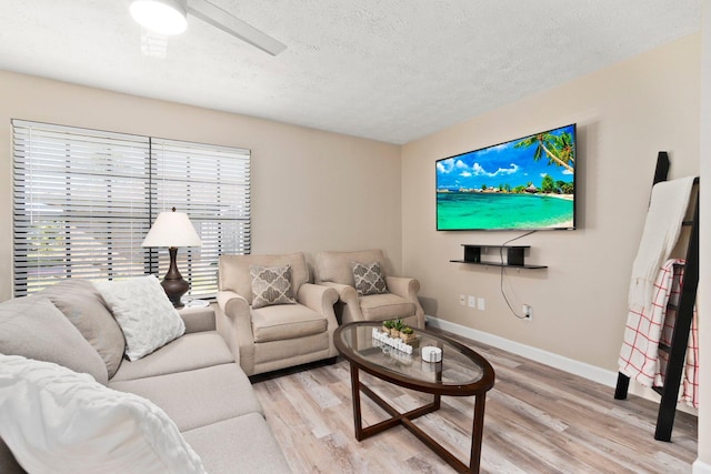 1251 SW Sudder Ave, Port Saint Lucie, FL 34953 - living area with light wood-style flooring, a textured ceiling, and a ceiling fan