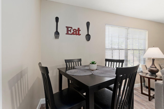 1251 SW Sudder Ave, Port Saint Lucie, FL 34953 - dining room with light wood-style floors and baseboards