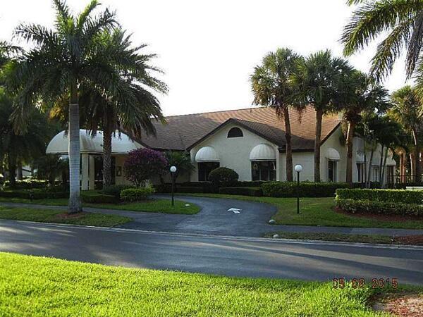 3350 Perimeter Dr Unit 1323, Greenacres, FL 33467 - single story home with stucco siding, curved driveway, and a front yard