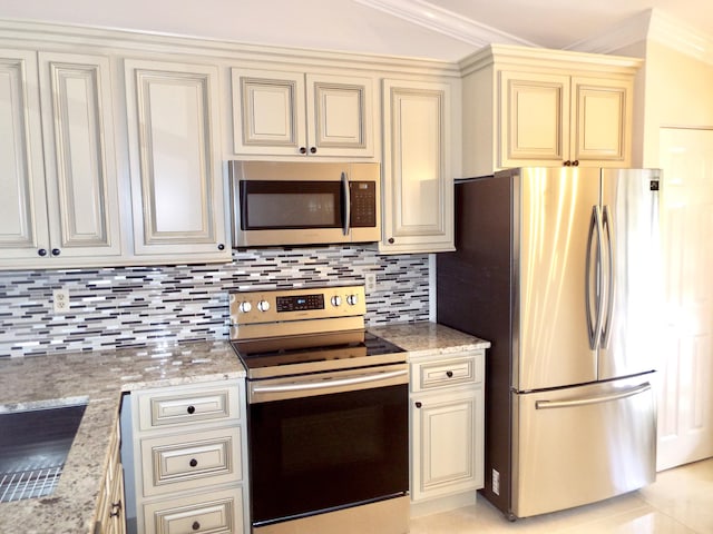 3350 Perimeter Dr Unit 1323, Greenacres, FL 33467 - kitchen featuring stainless steel appliances, cream cabinets, crown molding, decorative backsplash, and light stone countertops