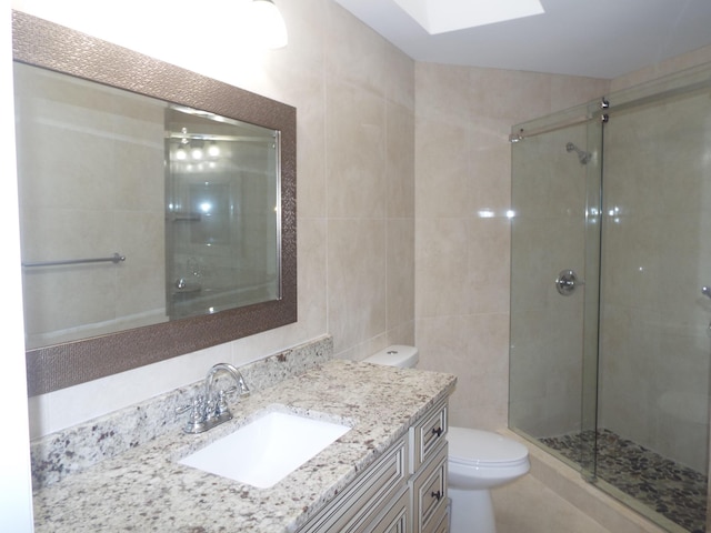 3350 Perimeter Dr Unit 1323, Greenacres, FL 33467 - bathroom featuring tile walls, vanity, a stall shower, and a skylight