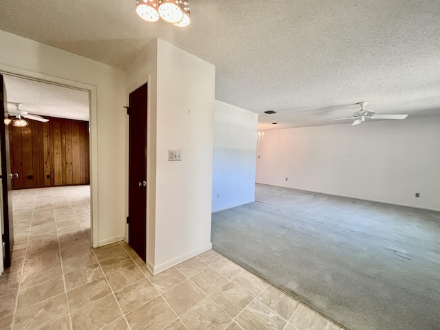 115 15th Ave, Vero Beach, FL 32962 - empty room featuring ceiling fan, a chandelier, a textured ceiling, and light carpet