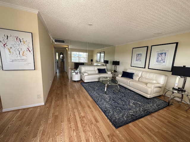 313 Normandy Unit G, Delray Beach, FL 33484 - living area featuring crown molding, a textured ceiling, and wood finished floors