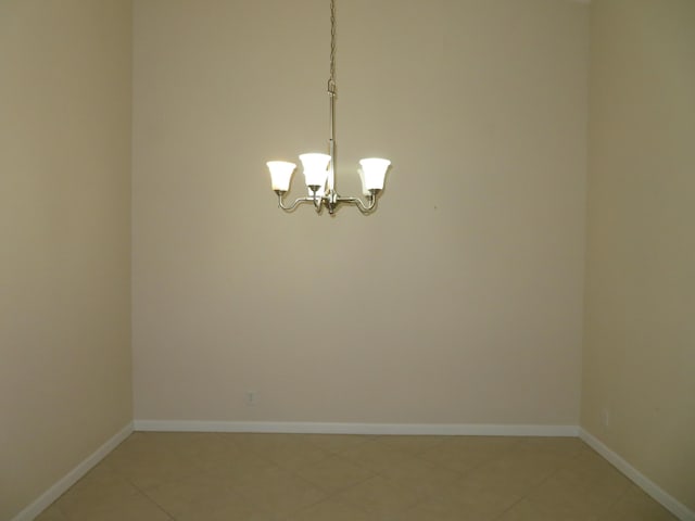 2357 Windjammer Way, West Palm Beach, FL 33411 - spare room featuring light tile patterned floors and a chandelier