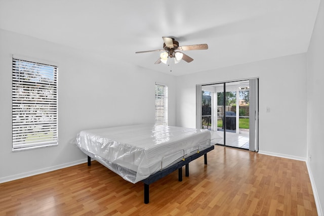 11784 Laurel Valley Cir, Wellington, FL 33414 - bedroom featuring access to exterior, light wood-style floors, and a ceiling fan