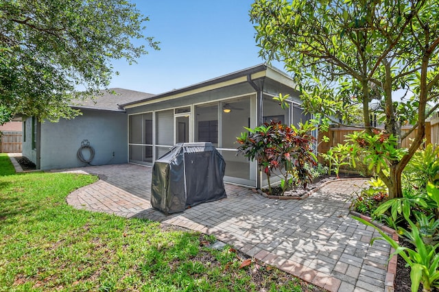 11784 Laurel Valley Cir, Wellington, FL 33414 - rear view of house featuring stucco siding, a patio, and a sunroom
