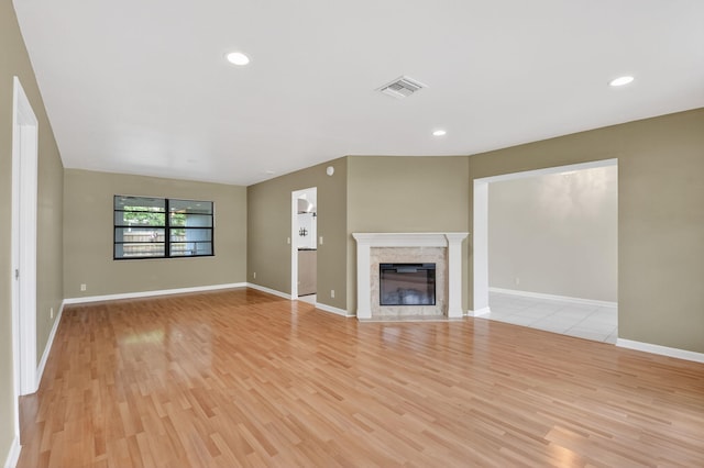 11784 Laurel Valley Cir, Wellington, FL 33414 - unfurnished living room featuring light wood-style floors, a glass covered fireplace, and recessed lighting