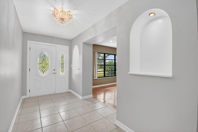 11784 Laurel Valley Cir, Wellington, FL 33414 - foyer entrance featuring light tile patterned flooring, a chandelier, and arched walkways