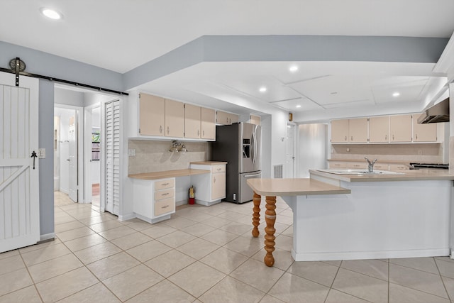 11784 Laurel Valley Cir, Wellington, FL 33414 - kitchen with stainless steel refrigerator with ice dispenser, light countertops, light tile patterned floors, cream cabinetry, and recessed lighting