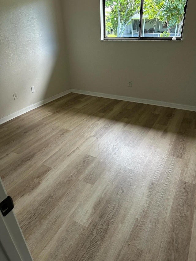 1942 SE Camilo St, Port Saint Lucie, FL 34952 - empty room featuring baseboards and wood finished floors