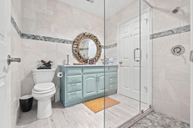 1951 SE Erwin Rd, Port Saint Lucie, FL 34952 - bathroom featuring a shower stall, vanity, and tile walls