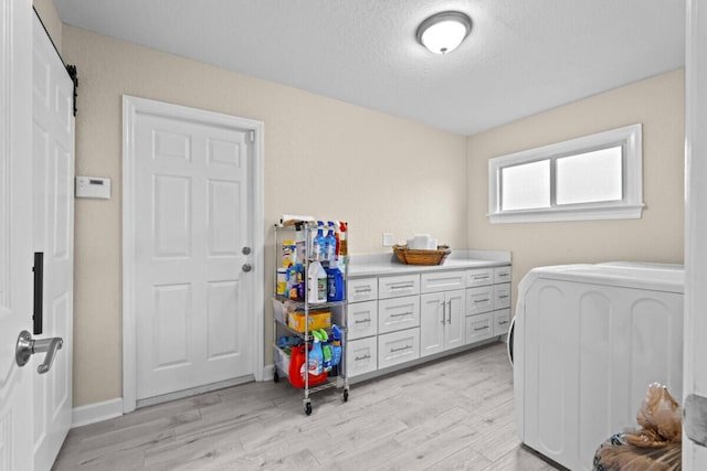 1951 SE Erwin Rd, Port Saint Lucie, FL 34952 - bedroom featuring light wood-style flooring, washer / dryer, and a textured ceiling