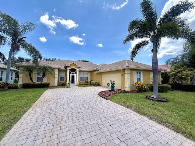 431 NW Canterbury Ct, Port Saint Lucie, FL 34983 - ranch-style home with stucco siding, decorative driveway, a garage, and a front lawn