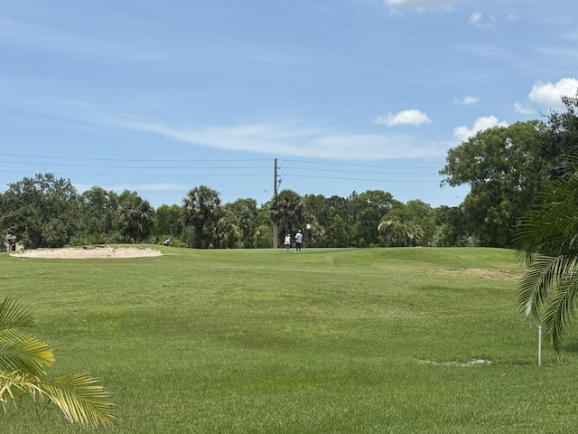 431 NW Canterbury Ct, Port Saint Lucie, FL 34983 - view of community with a yard, view of wooded area, and golf course view