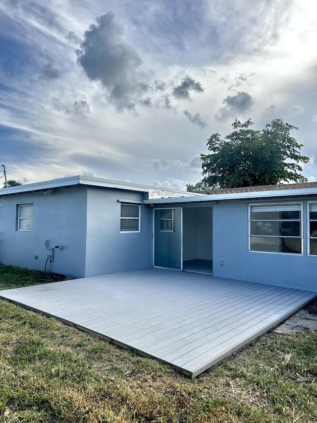 790 Sarazen Dr, West Palm Beach, FL 33413 - rear view of house with stucco siding and a deck