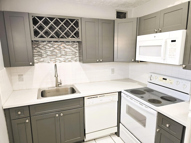 89 Saxony B B, Delray Beach, FL 33446 - kitchen with white appliances, tasteful backsplash, gray cabinets, and light countertops