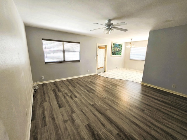 89 Saxony B B, Delray Beach, FL 33446 - unfurnished room featuring a ceiling fan, dark wood-style floors, and a chandelier