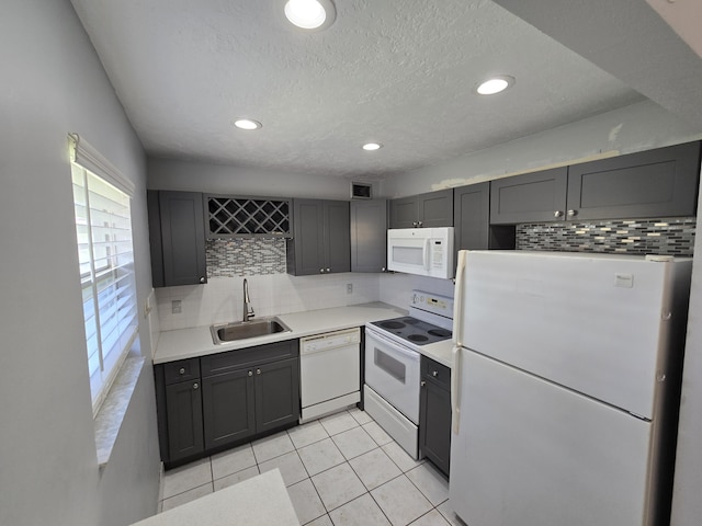 89 Saxony B B, Delray Beach, FL 33446 - kitchen with white appliances, backsplash, light tile patterned floors, light countertops, and recessed lighting