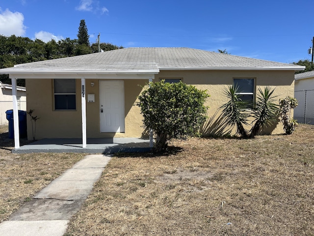 824 W 5th St, Riviera Beach, FL 33404 - view of front of house featuring stucco siding and a porch