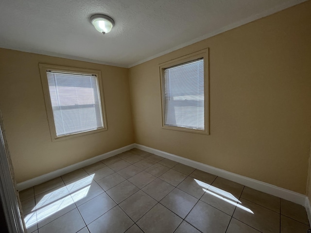 824 W 5th St, Riviera Beach, FL 33404 - spare room with light tile patterned floors, ornamental molding, and a textured ceiling