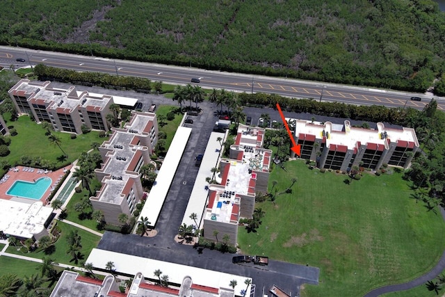 3492 NE Causeway Blvd Unit 104, Jensen Beach, FL 34957 - drone / aerial view of a heavily wooded area and a pool area